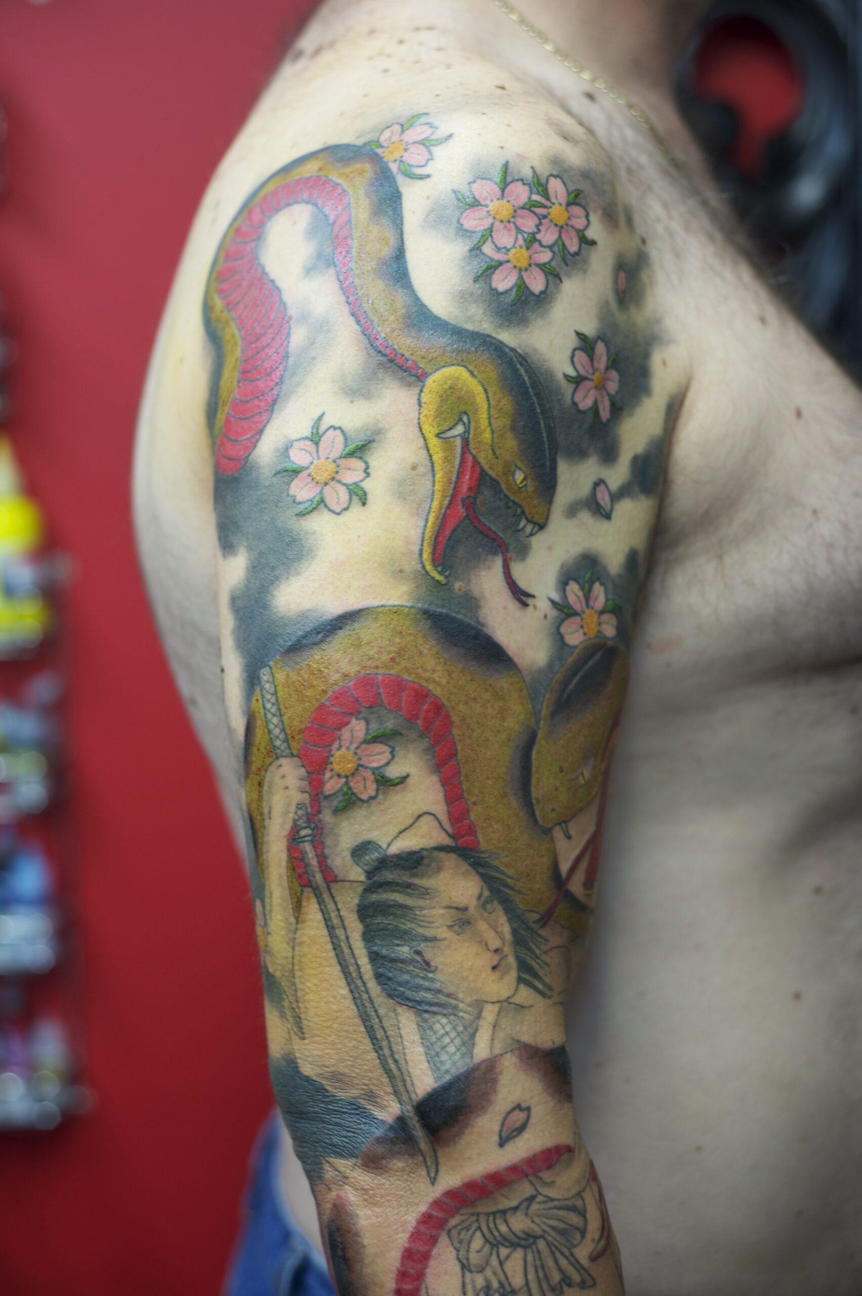 Japanese snake (hebi) sleeve tattoo with cherry blossoms and a sword-carrying figure – Japanese tattoo Perth, Western Australia